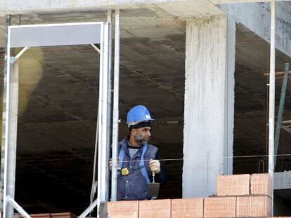 Tres obreros trabajan en la construcci&oacute;n de una vivienda de Bilbao.