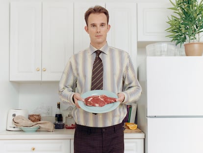 Man Holding Raw Steak on Plate