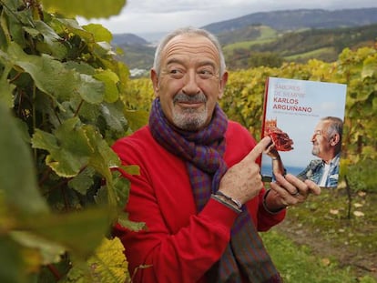 Karlos Arguiñano posa con su último libro en el viñedo de su bodega de chacolí.