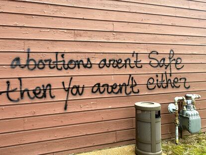 Threatening graffiti is seen on the exterior of Wisconsin Family Action offices in Madison, Wis., May 8, 2022