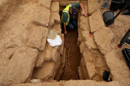 A Palestinian archaeologist removes the sand from a skeleton in a grave at the Roman cemetery in Jebaliya northern Gaza Strip, Saturday, Sept. 23, 2023.