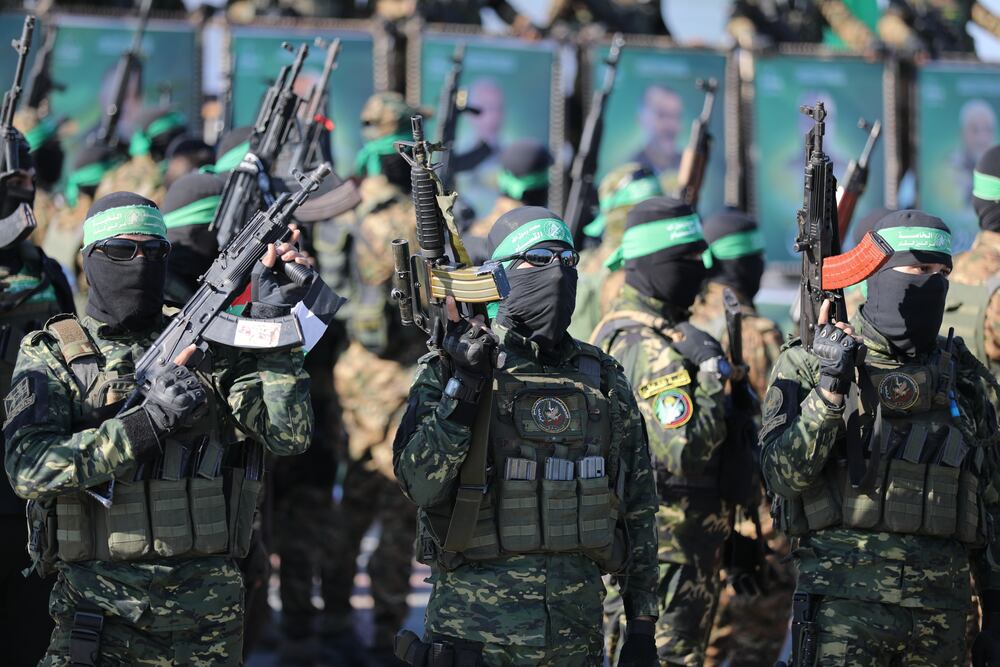 GAZA CITY, GAZA - FEBRUARY 01: Al-Qassam Brigades, the armed wing of Hamas, hands over Israeli hostage Keith Samuel Siegel in Gaza Port to the International Committee of the Red Cross on Saturday as part of the ongoing prisoner exchange deal in Gaza City, Gaza on February 01, 2025. (Photo by Dawoud Abo Alkas/Anadolu via Getty Images)