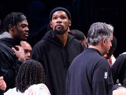 Brooklyn Nets forward Kevin Durant, center, looks on from the bench during the second half of an NBA basketball game against the Los Angeles Lakers, Monday, Jan. 30, 2023, in New York.