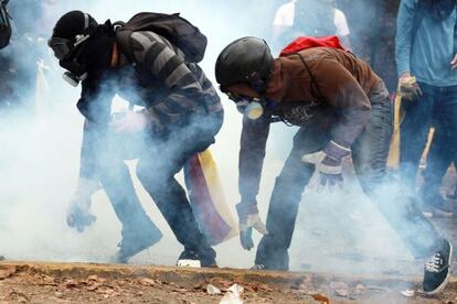 Two demonstrators take part in a protest in Caracas.