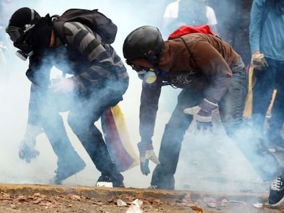 Two demonstrators take part in a protest in Caracas.