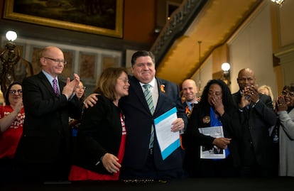 Illinois Gov. J.B. Pritzker hugs gun control advocate Maria Pike