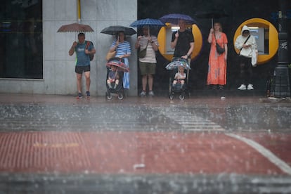 Un grupo de personas se refugia de la intensa lluvia el sábado en Valencia. 
