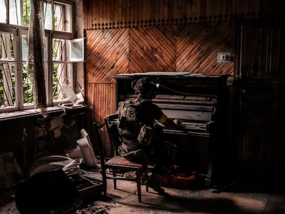 A Ukrainian soldier plays piano in a damaged building, amid Russia's attack on Ukraine, in the frontline town of Chasiv Yar in Donetsk region, Ukraine, June 25, 2024.