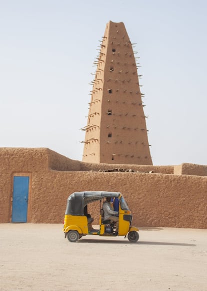 Los taxi-moto están cada vez más presenten en Agadez. En la foto, uno de ellos pasa delante del principal atractivo turístico de la ciudad, su mezquita construida en tierra, declarada Patrimonio Mundial de la Unesco en 2013.
