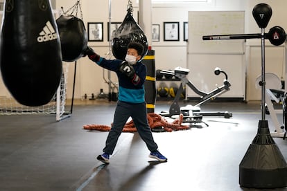 Student hitting a punching bag at the Downtown Boxing Gym, in Detroit, Michigan