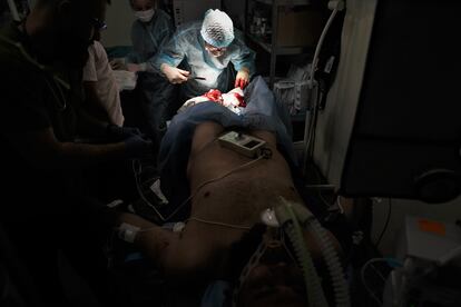 A soldier wounded by a land mine is operated on.