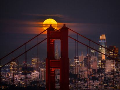 A supermoon rises behind the Golden Gate Bridge and the San Francisco skyline as seen from Sausalito, Calif. on Thursday, Aug. 11, 2022.