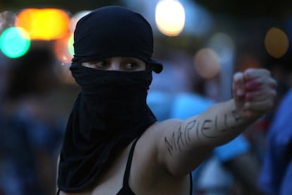 A protester with Marielle written on her arm in reference to the murdered Marielle Franco