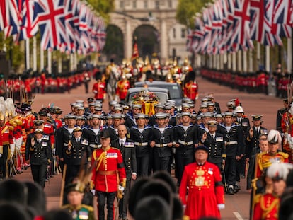 The coffin of Queen Elizabeth II is pulled past Buckingham Palace following her funeral service in Westminster Abbey in central London, Monday, Sept. 19, 2022. The Queen, who died aged 96 on Sept. 8, will be buried at Windsor alongside her late husband, Prince Philip, who died last year. (AP Photo/Vadim Ghirda, Pool)