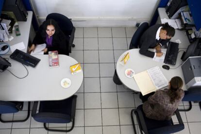 Dos funcionarias atienden al público en el servicio de la administración tributaria de México.