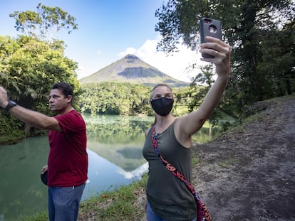Tourists near the Arenal volcano, north of San Jose, Costa Rica.