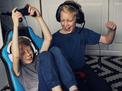 Two boys having fun playing video games together