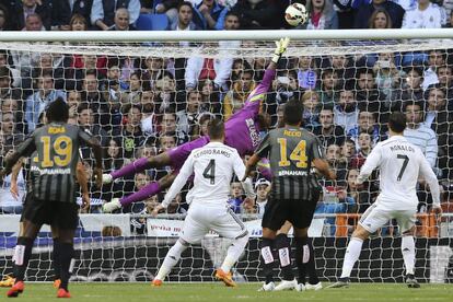 Kameni despeja un disparo del Madrid ante la mirada de Ramos y Cristiano.