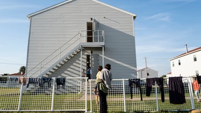 Afghan refugees in front of temporary housing on an Army base at Ft. McCoy, Wisconsin.