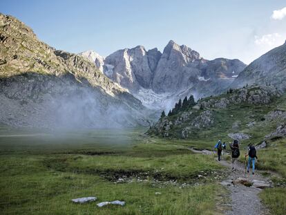 Un grupo de senderistas con el macizo de Vignemale al fondo, en el parque nacional de los Pirineos.