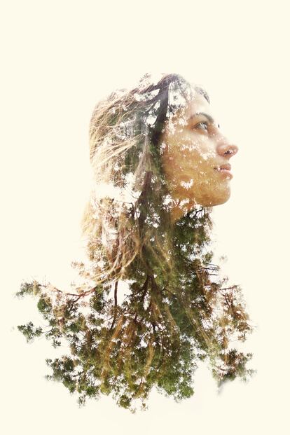 Double exposure of a young woman and trees