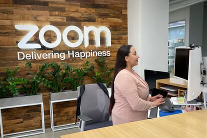 A woman works at Zoom headquarters on Friday, Feb. 3, 2023, in San Jose, Calif. Zoom is asking employees who live within a 50-mile radius of its offices to work onsite two days a week.