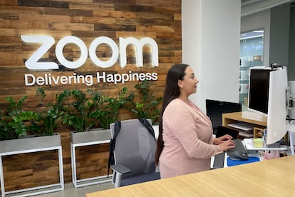 A woman works at Zoom headquarters on Friday, Feb. 3, 2023, in San Jose, Calif. Zoom is asking employees who live within a 50-mile radius of its offices to work onsite two days a week.