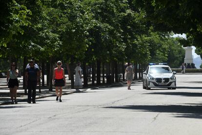 Agentes de la Policía Municipal anuncian a los viandantes del cierre del parque de El Retiro por viento y calor, ayer, viernes.