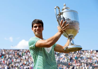 Spain's Carlos Alcaraz celebrates with the trophy after winning his final match against Australia's Alex de Minaur.