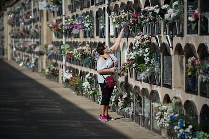 A woman places flowers in the Poblenou cemetery in Barcelona.