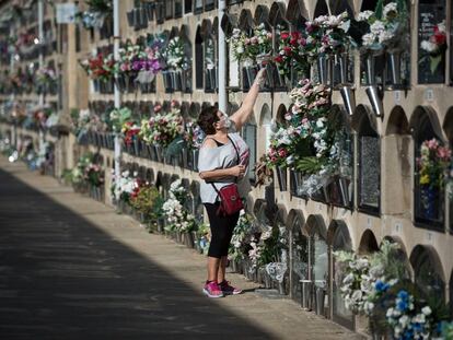 A woman places flowers in the Poblenou cemetery in Barcelona.