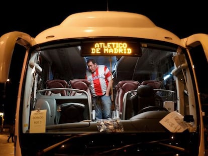 Un aficionado del Atlético aguarda dentro de un autobús.