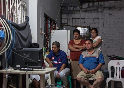 Familiares de los cinco desaparecidos en Tierra Blanca, frente al televisor.