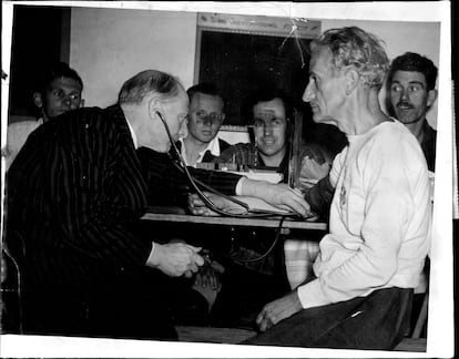 A doctor takes Percy Cerutty's blood pressure before a race in 1956.