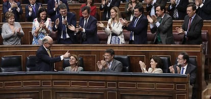 Deputies with Spain's ruling Popular Party applaud following the budget vote.