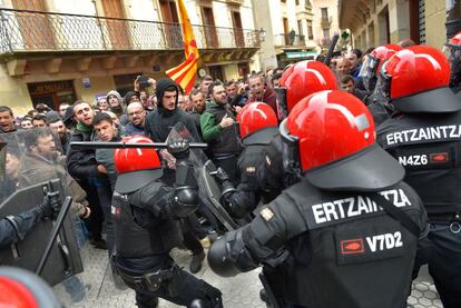 Un agentes utiliza la porra para dispersar a los manifestantes tras el mitin de Albert Rivera.