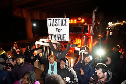 Protesters march down the street Friday, Jan. 27, 2023, in Memphis, Tenn., as authorities release police video depicting five Memphis officers beating Tyre Nichols.