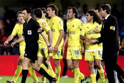Los jugadores del Villarreal siguen al árbitro que dejó de señalar un penalti al mexicano Guille Franco.