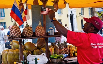 Un vendedor de frutas decora su puesto en La Habana.