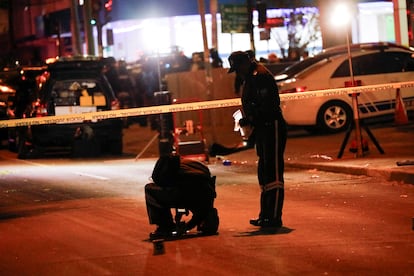 Forensic officials work outside the site where Ecuadorean presidential candidate Fernando Villavicencio was killed.