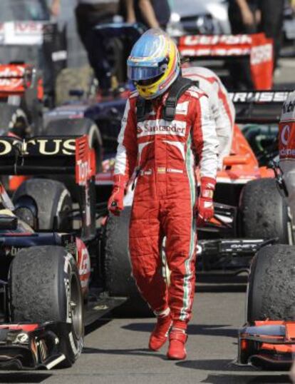 Fernando Alonso observa el estado de los neumáticos tras concluir la conclusión del GP de Hungría