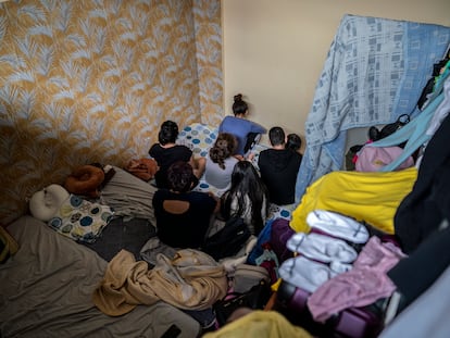 The seven members of a Peruvian immigrant family in the room they share in a basement in Madrid's Usera district.