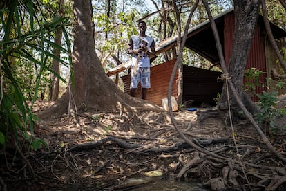 Mawdo Barry awaits the boats of tourists who come to visit the chimpanzees along the Gambia river. He is one of the guards who is trained to care for the apes.