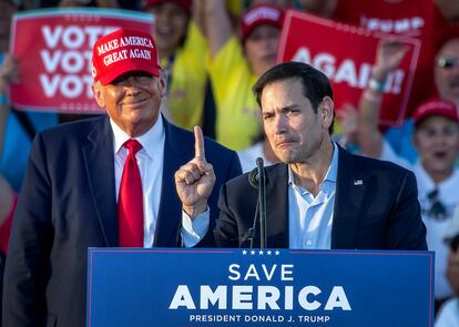 Florida Senator Marco Rubio (R) speaks next to former US President Donald Trump (L)