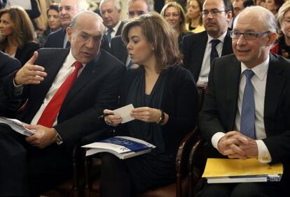 La vicepresidenta del Gobierno, Soraya S&aacute;enz de Santamar&iacute;a, junto al secretario general de la OCDE, &Aacute;ngel Gurr&iacute;a, y el ministro de Hacienda, Crist&oacute;bal Montoro, hace una semana en Madrid.