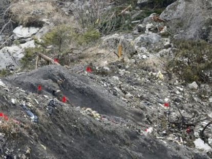 Members of the recovery team walk among debris from the Germanwings plane at the crash site.