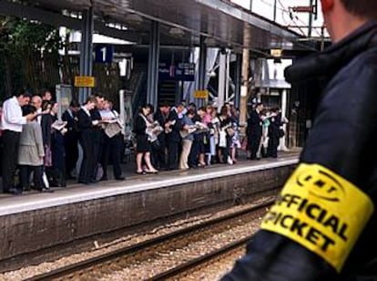 Usuarios del metro aguardan en una estación ante la presencia de un piquete oficial.