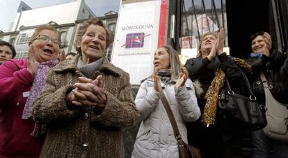 Aurelia Rey (front), is applauded by supporters in A Coru&ntilde;a on Monday after a judge halted an eviction order against her. 