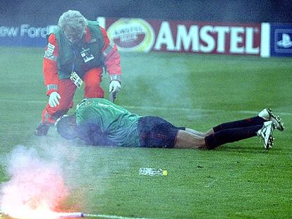 El portero del Milan, Dida, cae al suelo tras recibir el impacto de una bengala.