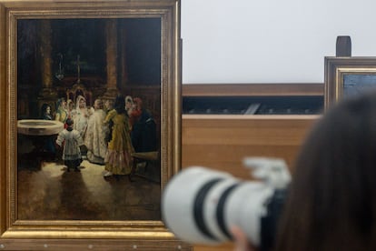 A camera photographs one of the seized paintings.
